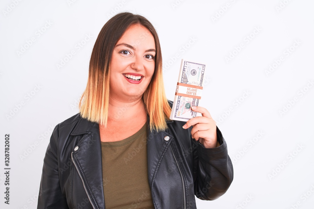 Young beautiful woman holding dollars standing over isolated white background with a happy face standing and smiling with a confident smile showing teeth Young beautiful woman holding dollars standing over isolated white background with a happy face standing and smiling with a confident smile showing teeth