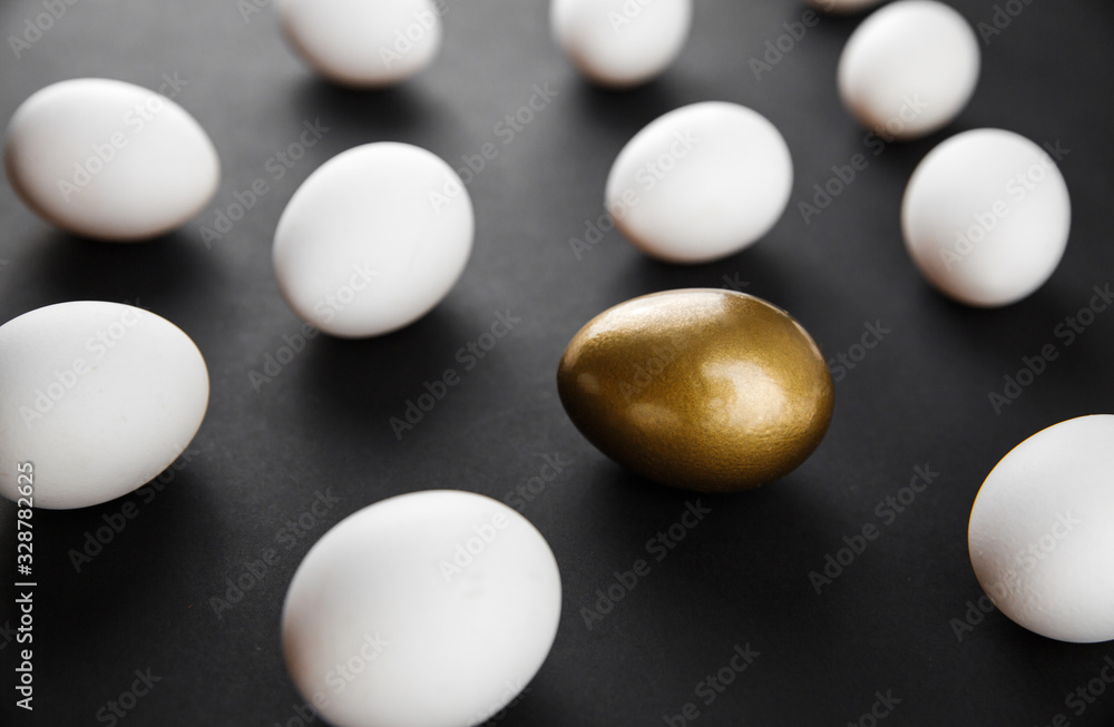 White and gols eggs arranged on black background White and gols eggs arranged on black background