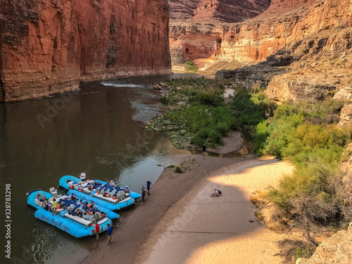 Colordo River trip stopped at beach of South Canyon.  Two blue rafts on the river's edge with ropes in the sand.  Redwall Limestone of Marble Canyon in the Grand Canyon National Park, Arizona photo