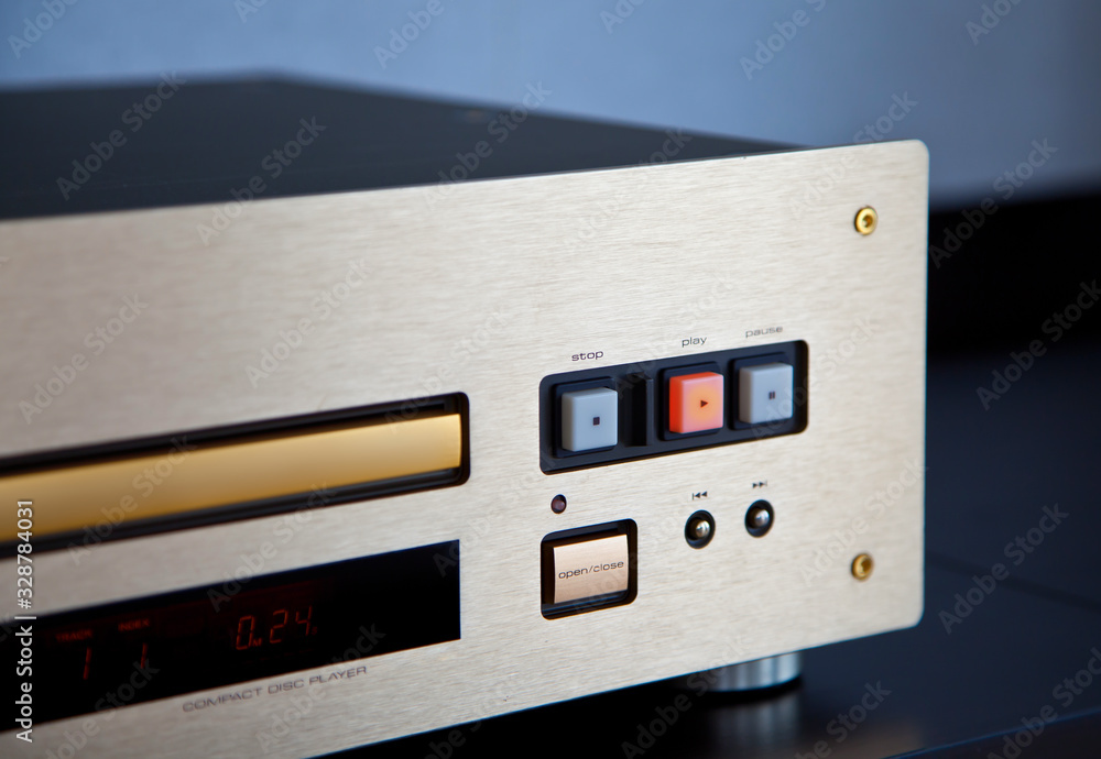 Expensive Stereo CD Player with Golden Front Panel Plays Music on Compact Disk Expensive Stereo CD Player with Golden Front Panel Plays Music on Compact Disk