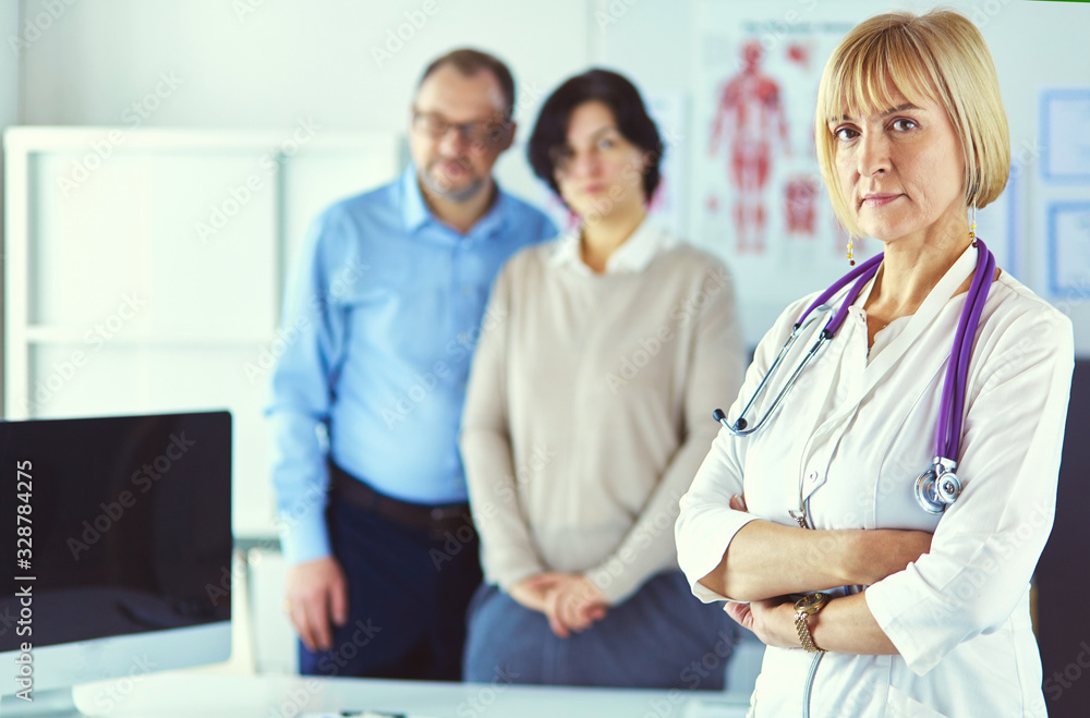 Smiling medical doctor with stethoscope and elderly couple Smiling medical doctor with stethoscope and elderly couple