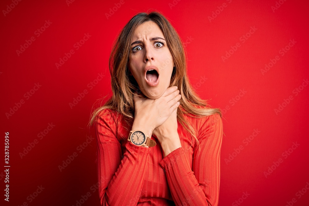Young beautiful brunette woman wearing casual turtleneck sweater over red background shouting suffocate because painful strangle. Health problem. Asphyxiate and suicide concept. Young beautiful brunette woman wearing casual turtleneck sweater over red background shouting suffocate because painful strangle. Health problem. Asphyxiate and suicide concept.