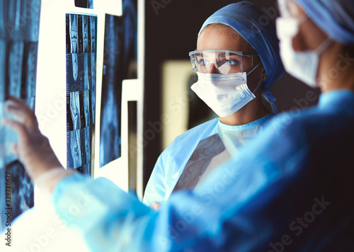 Two female women medical doctors looking at x-rays in a hospital