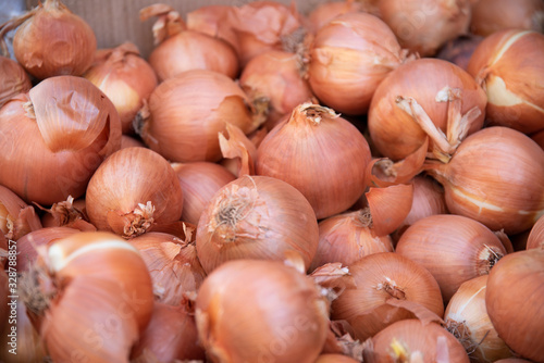 Freshly collected onions from agriculture for kitchen use in a street market for sale to the consumer public that comes to purchase