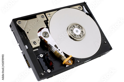 Hard disk drive isolated on white background. A computer's HDD data storage without protective cover, show the magnetic disk and electronic components inside the device.