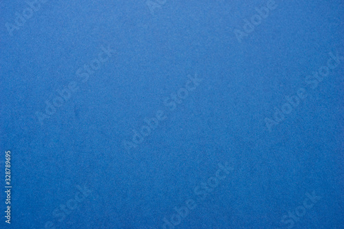 Classic blue background - abstract color trend year background. Texture and texture - paper deep blue color. Top view and soft focus.