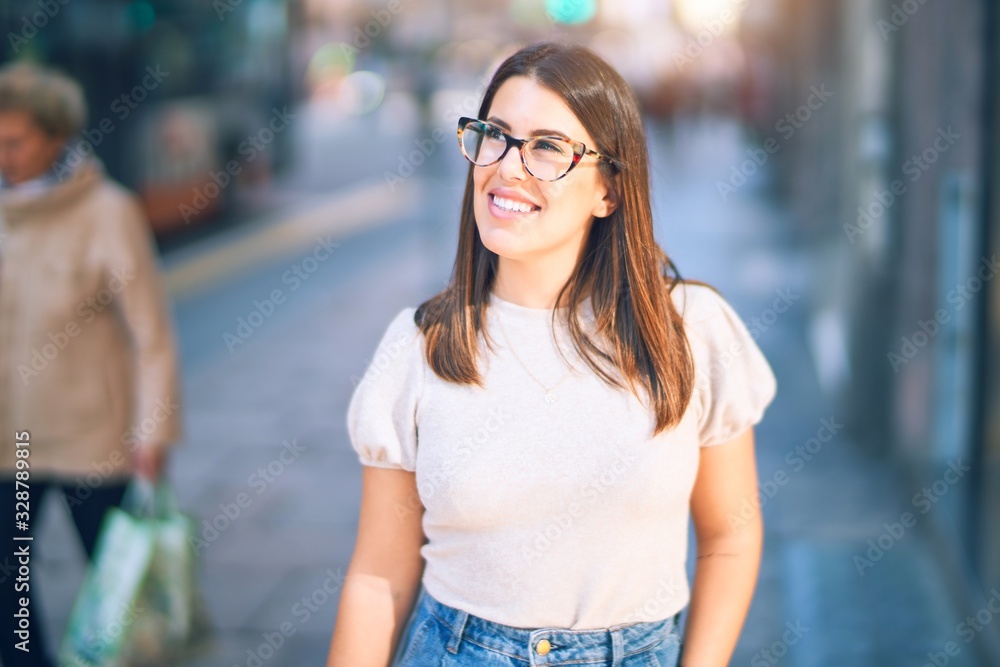 Young beautiful woman smiling happy and confident. Standing with smile on face at the town street Young beautiful woman smiling happy and confident. Standing with smile on face at the town street