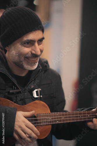 man playing ukulele