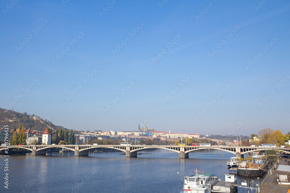 Panorama of the Old Town of Prague, Czech Republic, with a focus on Jiraskuv Most bridge and the Prague Castle (Hrad Praha) seen from the Vltava river. The castle is a touristic landmark of the city