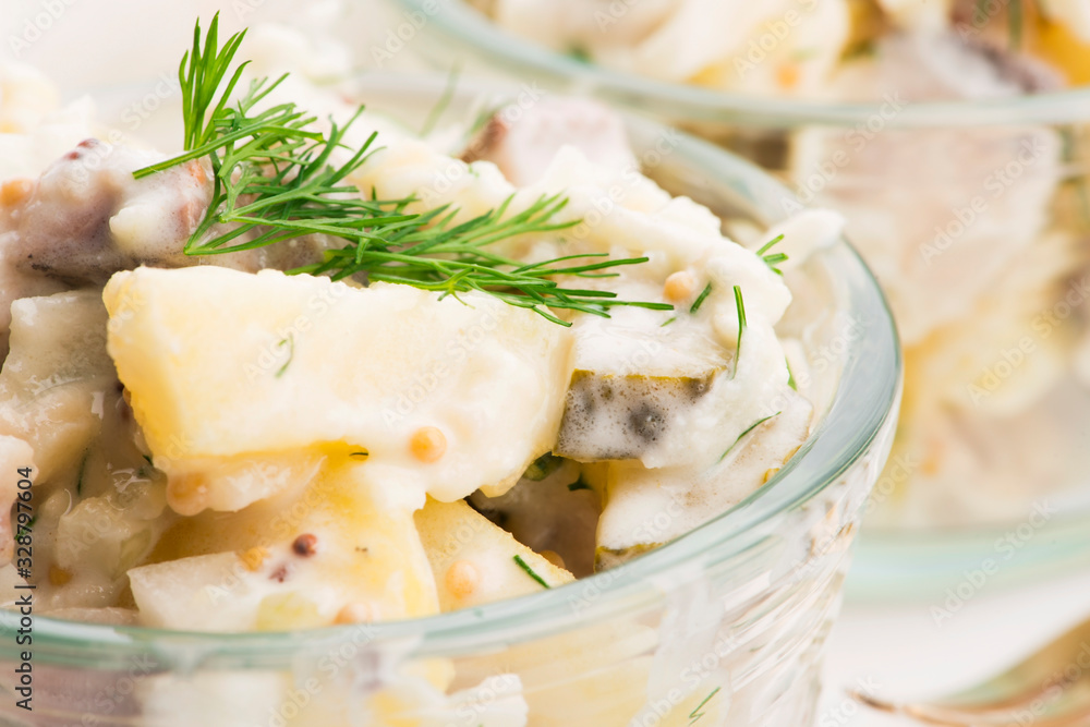 Salad rasols made of herring, cucumber and potato, dressed with mayonnaise and mustard Salad rasols made of herring, cucumber and potato, dressed with mayonnaise and mustard