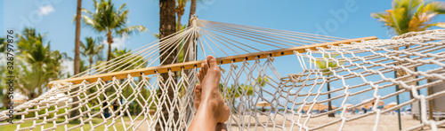 Caribbean beach selfie girl relaxing on hammock panoramic banner travel background panorama. Summer travel vacation holidays.