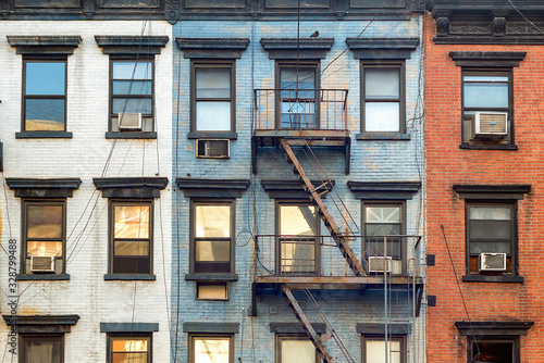 Photography Red, white and blue facade of pre-war residential building in urban New York Cit