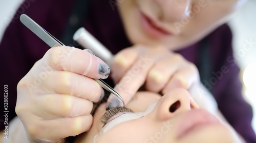 Beautician making eyelash lamination procedures. Modern eyelash care treatment procedures - staining, curling, laminating and extension for lashes.