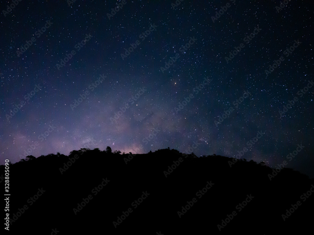 beautiful night sky from milky way galaxy with stars and meteor over mountain at national park, Thailand on February 2020