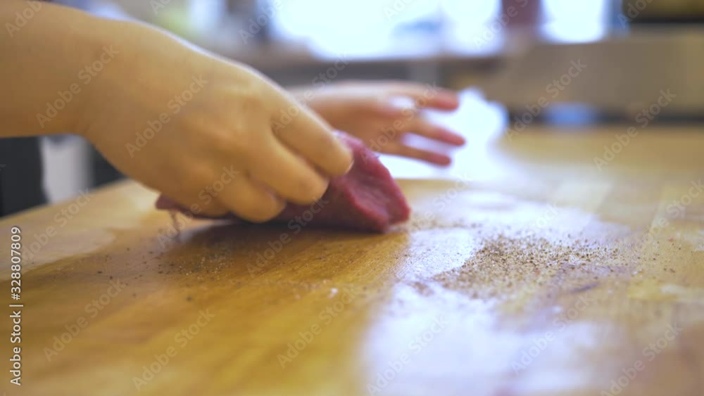 Piece of fresh meat is pepper on wooden table Piece of fresh meat is pepper on wooden table