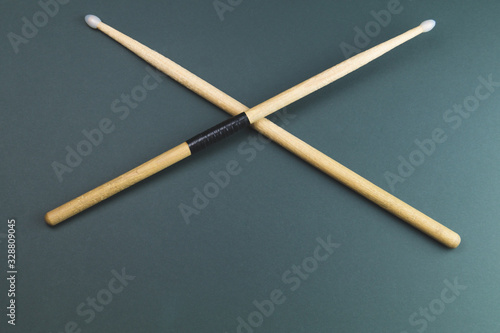 A pair of wooden drumsticks isolated on color background