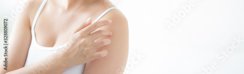 Принти на полотні Beautiful young asian woman applying cream and treatment for skin care touch on shoulder, girl with lotion and moisturizing for health body part, lifestyle and beauty cosmetic concept, banner website