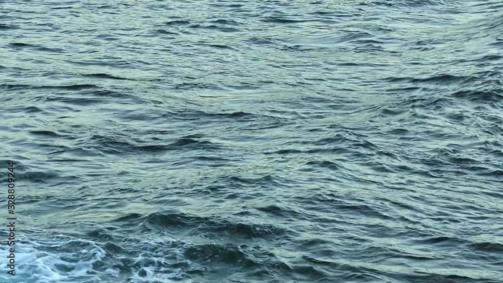 The water surface of the Atlantic ocean with ripples and waves near the shores of Canary Islands. The water surface of the Atlantic ocean with ripples and waves near the shores of Canary Islands.