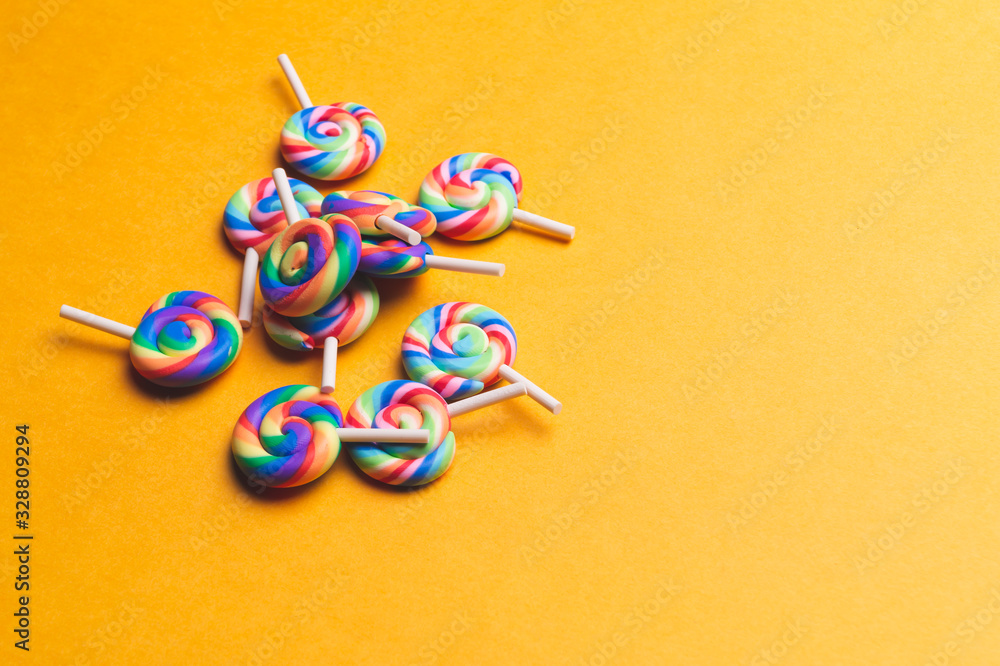 Obraz premium Lollipops close up. colorful candies on a yellow background. copy space