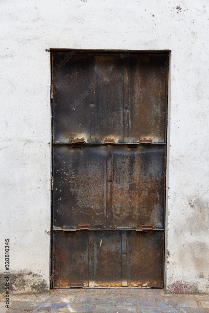 old rusting metal door in wall