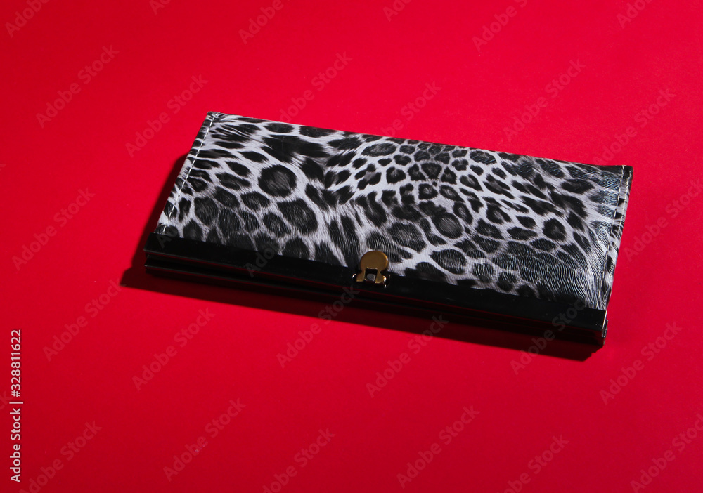 Stylish wallet on red background. Fashion minimalism. Stylish wallet on red background. Fashion minimalism.