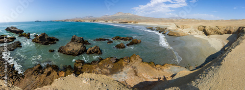 Panoramic view of a rocky beach with  algaes and blue seawater at Huarmey´s seaside in Ancash region, Peru photo