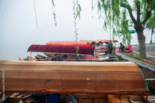 Traditional chinese boat  view in Wuhan city Donghu east lake during rainy season.