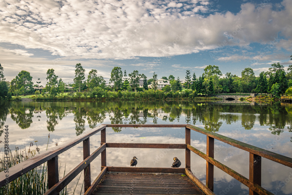 The morning sunrise brings a tranquil scene of reflection 