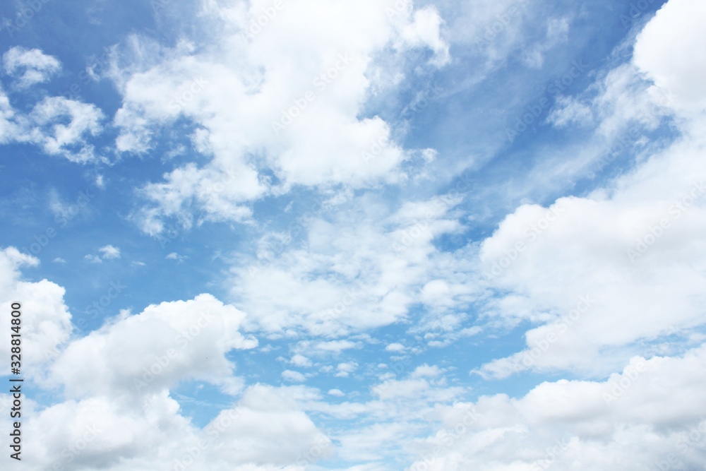 Many white clouds against bright blue sky on sunny day Many white clouds against bright blue sky on sunny day