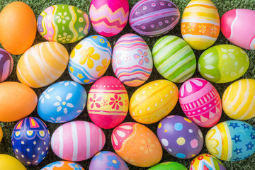 Happy Easter with colorful eggs at paintbrush for do it yourself on the grass with close up from top view