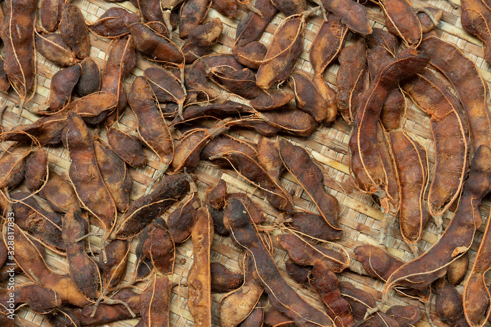 Dried tamarind, peeled and placed on rattan trays. Dried tamarind, peeled and placed on rattan trays.