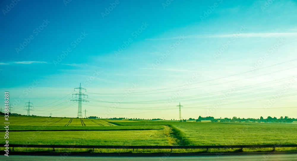 Germany, Frankfurt, Sunrise, a large green field with trees in the background Germany, Frankfurt, Sunrise, a large green field with trees in the background