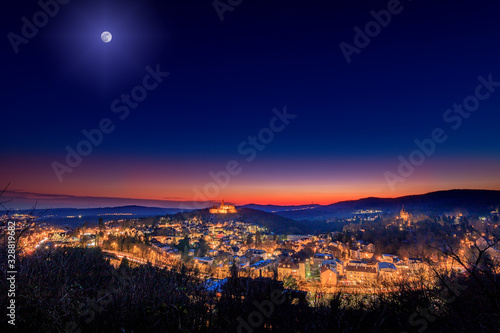 sunset in the mountains, this beautiful view can be found in Königstein, Germany. a great sunset in winter over a great hilly landscape with a village