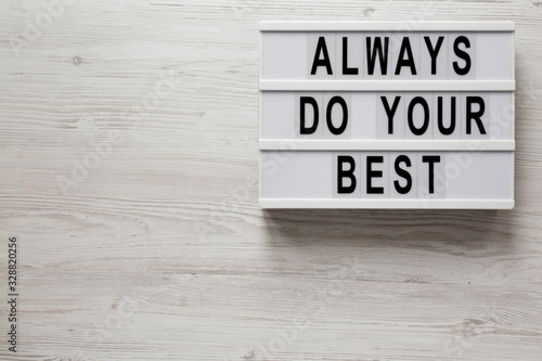 'Always do your best' words on a modern board on a white wooden surface, top view. Overhead, from above, flat lay. Space for text.