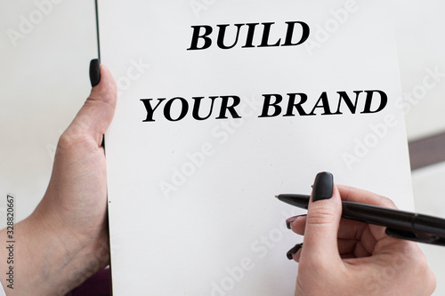 words build yoyr brand writes girl on a blank white sheet photo