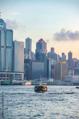 Star ferry of Hong Kong crossing Victoria Harbour at evening time © Bossa Art
