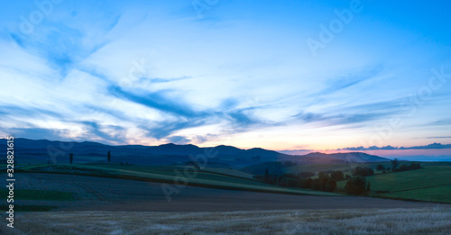 Paronama field of meadow on summer. Twilight sunset sky.