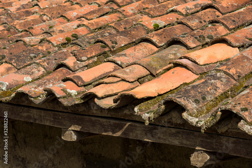 Tiled roof of an Andean house with moss in Peru