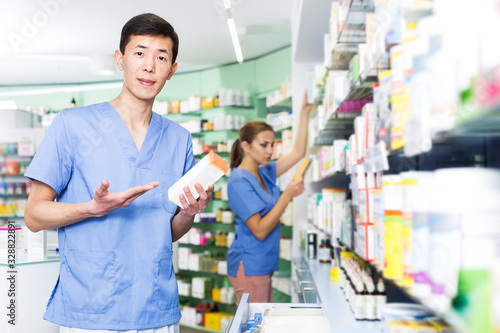 Pharmacist with medicines in pharmacy