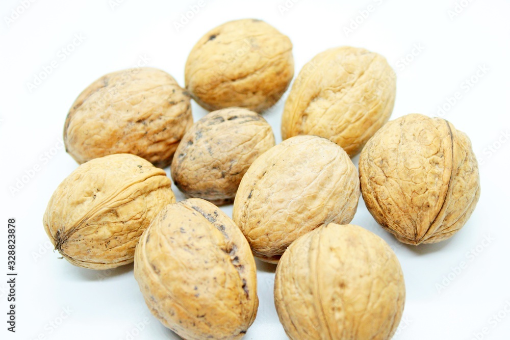 Beautiful ripe walnuts, located on a white background Beautiful ripe walnuts, located on a white background