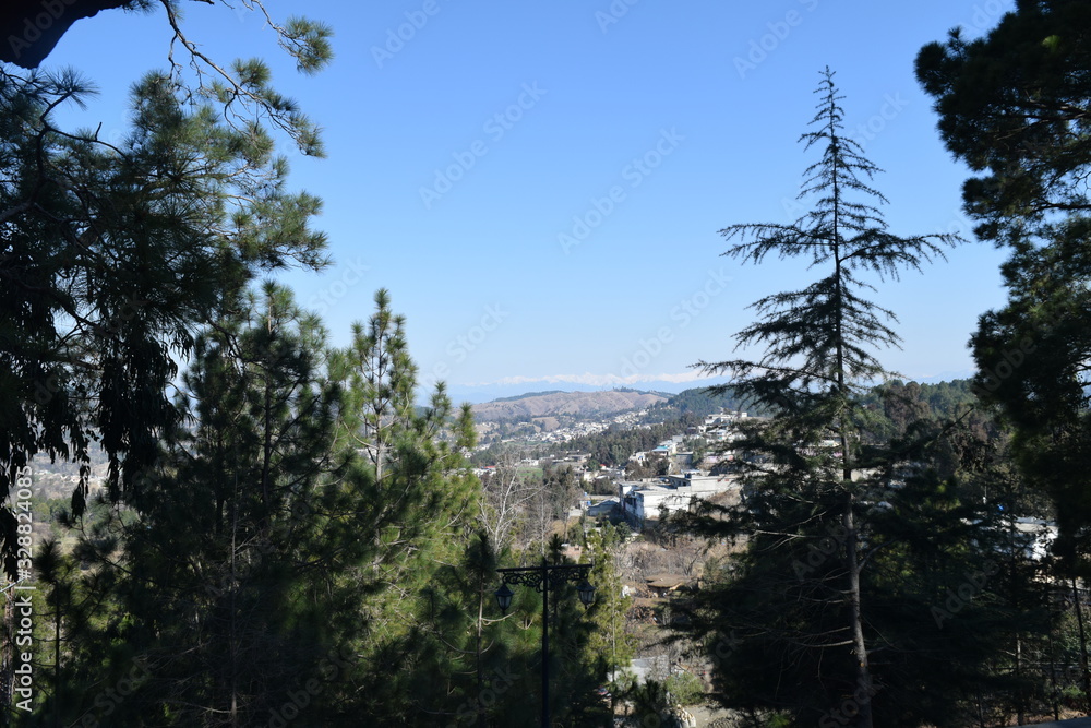 Beautiful view of snow covered mountain and homes in bright sunny day with clear blue sky Beautiful view of snow covered mountain and homes in bright sunny day with clear blue sky