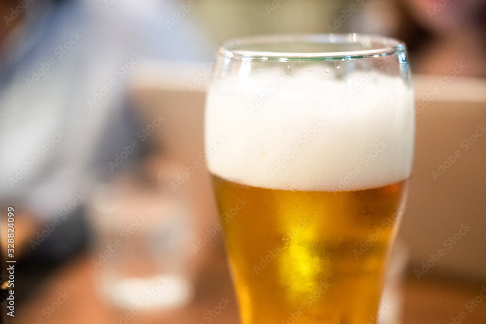 Long glass of fresh light beer with foam Long glass of fresh light beer with foam