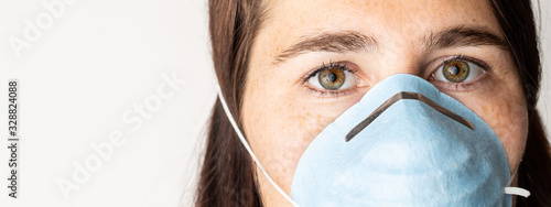 Φωτογραφία A woman is wearing a face mask for protection from the Corona Virus and has stocked up on her toilet paper stash in case of quarantine