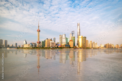 Shanghai city skyline Pudong side looking through Huangpu river on a sunny day. Shanghai, China. Beutiful vibrant panoramic image.
