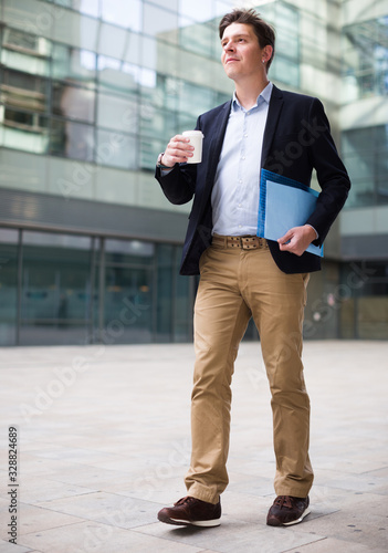 Portrait of cheerful male with documents