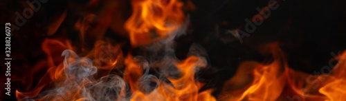 Abstract fire flame glowing burning on black dark background, photo for creative graphic design wallpaper, beautiful flame light motion of bonfire