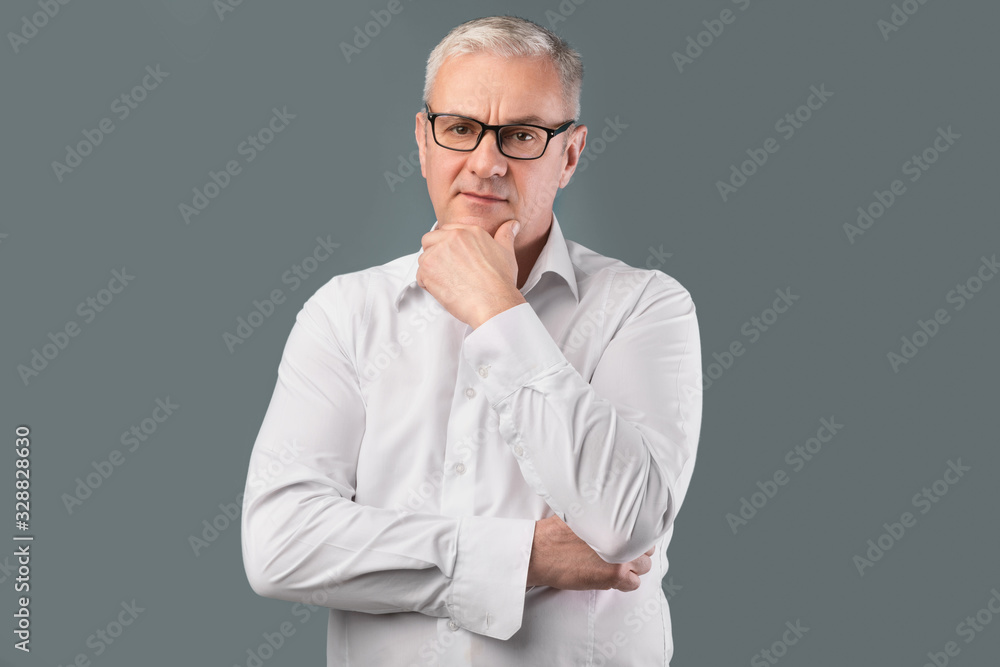 Senior pensive man portrait on gray background Senior pensive man portrait on gray background