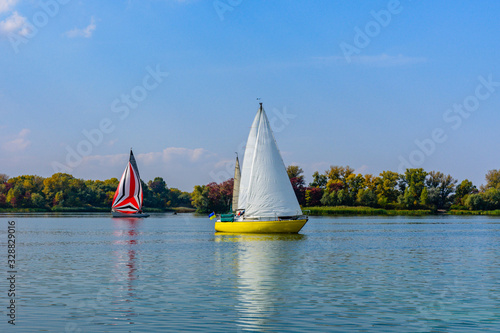 Yachts at the river Dnieper on autumn in Kremenchug, Ukraine. Sailing regatta