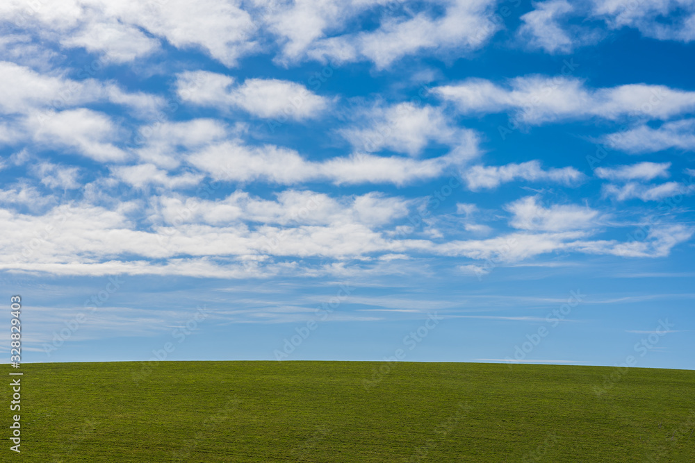 Landscape background with green grass mountain hill and blue sky with scattering white cloud. Landscape background with green grass mountain hill and blue sky with scattering white cloud.