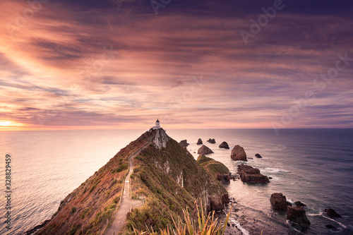 Morning sunrise at nugget point lighthouse. Famous attraction in Catlin coast, Otago, South Island, New Zealand. photo